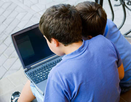 Two cute boy study on computer 
