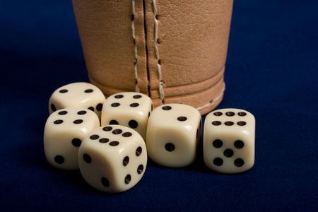 Dice cup and dice on background