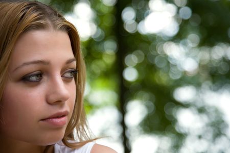 Portrait of young girl on forest backgroundの写真素材