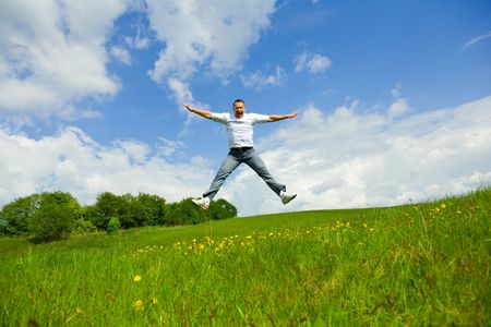 The man jumping on a lawnの写真素材