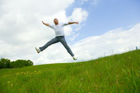 The man jumping on a lawn