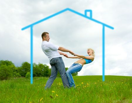 Young family jumping on a lawnの写真素材