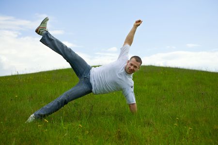 The man jumping on a lawnの写真素材