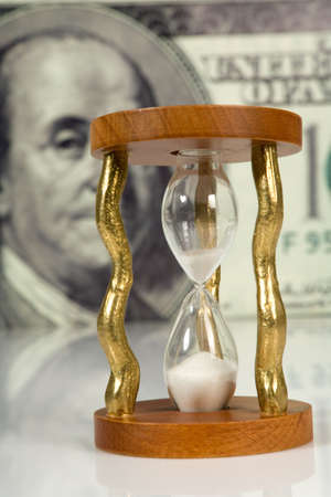 hourglass on big dollar background