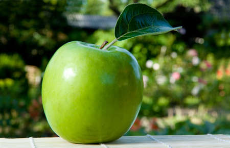 Green apple with green leafの写真素材