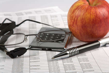 calculator and pen on a white backgroundの写真素材