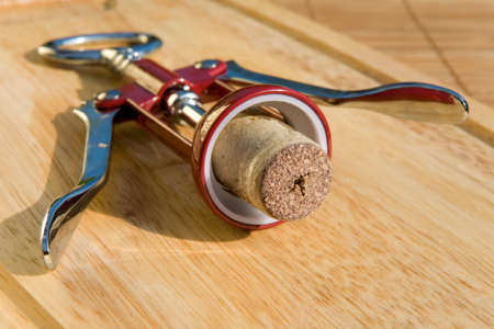 Corkscrew with stopper on boardの写真素材