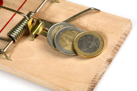 Mousetrap with coins isolated on whiteの写真素材