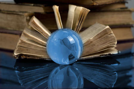 glass globe and the old bookの写真素材