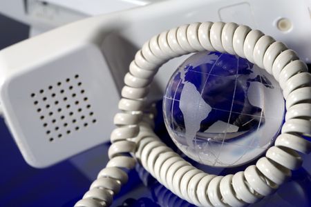  Glass globe with phone. Global communication concept.の写真素材