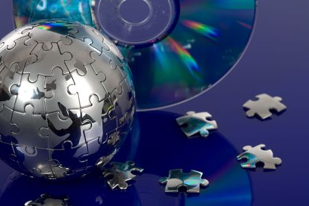 Globe puzzle with CD on blue backgroundの写真素材