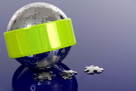Globe puzzle with reflector on blue background.の写真素材