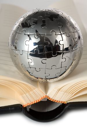 Globe puzzle with book on blue background.の写真素材
