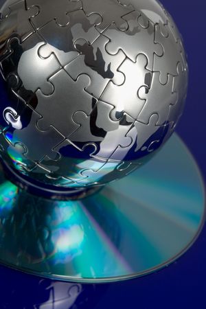 Globe puzzle with CD on blue backgroundの写真素材