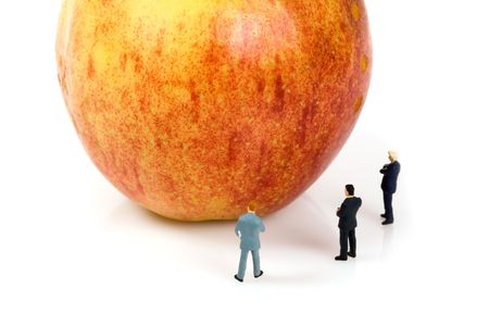 business team with a apple isolated over a white backgroundの写真素材