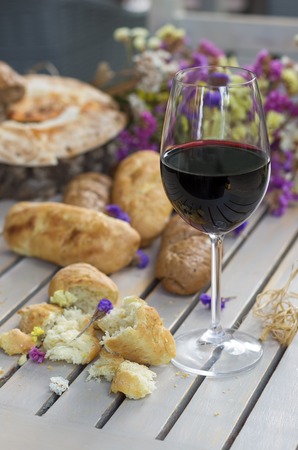 White French Bread on Wooden board with glass of Wineの写真素材
