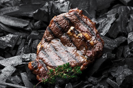 Beef steak on the charcoal. Place for your advertisement.の写真素材