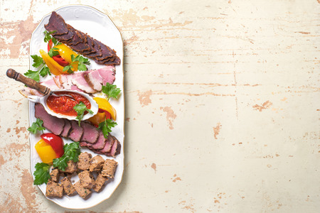 plate of meat delicacies of wild boar, wild duck, elk, hare top view, close-upの写真素材