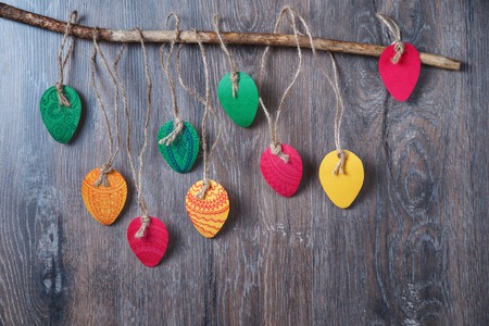 Colorful decorative Easter eggs made of paper on a wooden background. View from above with copy...