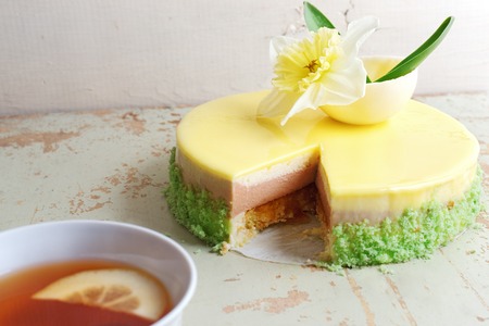 Passion fruit cake, mousse dessert with tropical flavor. Selective focus. Space for text, wooden background.の写真素材