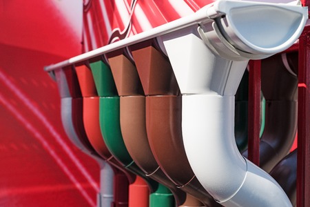 Closeup of rain gutter and downspout. Different color options. Selective focus.の写真素材