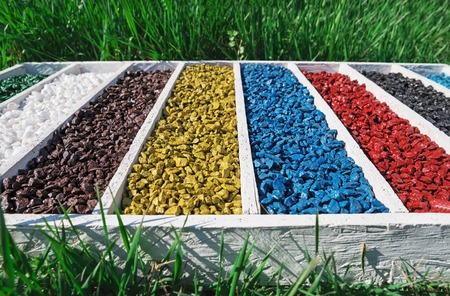 colorful rocks in wooden box On the green grass, art Aquarium Fish Tank Gravel Stones Color For decorationの写真素材