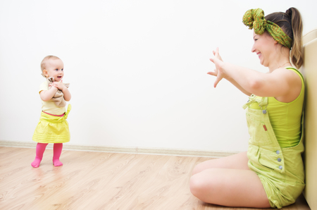 Mom and daughter play hide and seek at home.の写真素材