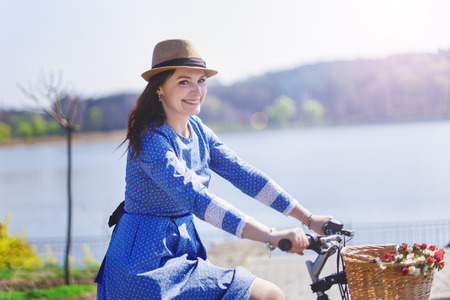 young beautiful woman riding a bicycle in a park. Active people. Outdoorsの写真素材