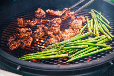 Succulent piece of meat cooking on a grill with a side of asparagus. Dining concept of nutrition. Buffet. Food. close-upの写真素材