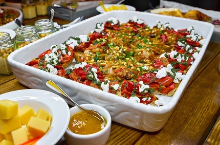 Buffet table with Bruschetta, Appetizers and different sauces. with hummus, beef, pate, avocado, tomatoes. on a wooden rustic table. Close-up. selective focus.の写真素材