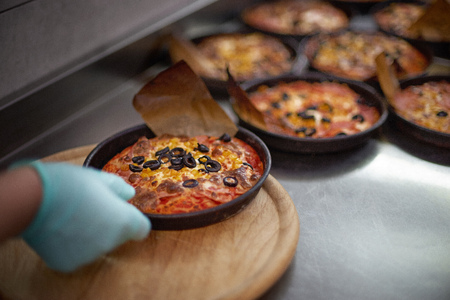 Preparation pizza for children, on an iron table. Close-up, italian fast food. selective focus, copy space.の写真素材