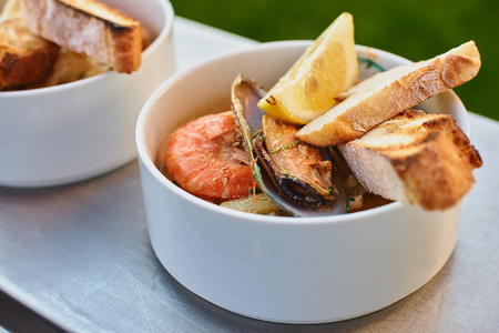 Mussels in wine with parsley and lemon. Seafood. Clams in the shells. Delicious snack for gourmands. Selective focusの写真素材