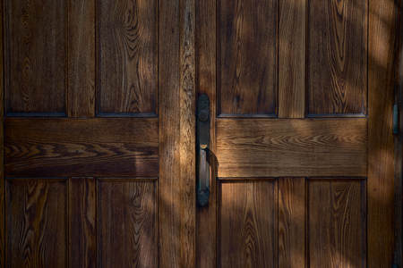 Old wooden closet door slightly open. Natural light. close upの写真素材