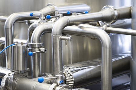 stainless steel pipe. Brewery production concept, industrial background, close up