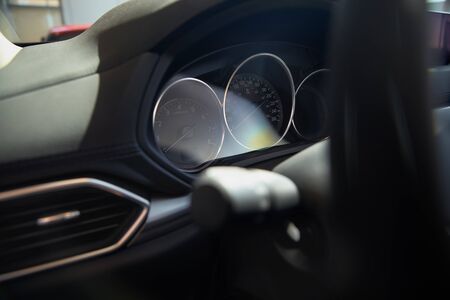 modern car speedometer and odometer at daytime. Concept of car sales, rent.