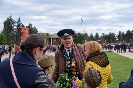 Chisinau, Moldova, May 9, 2019: war veteran receives congratulations on Victory Day. Children with parents give flowers celebrates the 74nd anniversary of the Victory.のeditorial素材