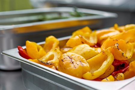 Colorful red and yellow paprika half cut into a baking sheet, ready after grilling. Ready meal Vegetable background. Selective focus. close upの写真素材