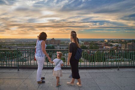 Montreal, Quebec, Canada, September 6, 2018: Tourists are watching the Sunset over the oratory of...