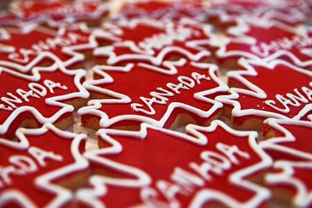 Gingerbread in the form of red, maple leaves, marked Canadian. in the window of the candy store. Selective focus. Close upの写真素材