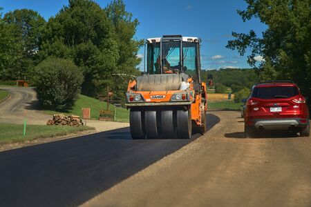 Compton, Quebec, Canada September 8, 2018: Laying a new asphalt on the road. Construction of the road.のeditorial素材