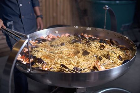Interesting restaurant which is using the super large pan for cooking their menu to attract tourists around.Concept about food preparation in the kitchenの写真素材