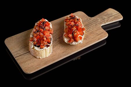 Bruschetta Italian, Toasted Garlic Bread with tomato on black background. Traditional italian cuisine. Culinary eating.の写真素材