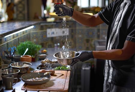 Food concept. The chef adds parmesan , The process of cooking spaghetti with seafood.の写真素材