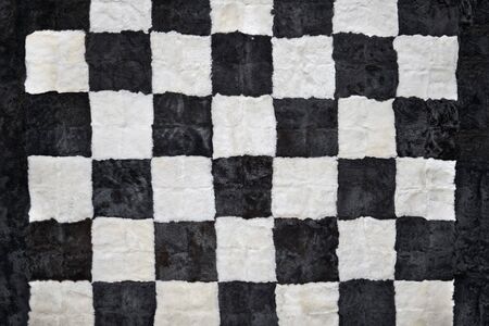 Close up of beautiful checkerboard style rug, fur texture, checkered backgroundの写真素材