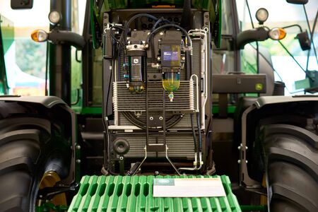 Chisinau, Moldova, October 22, 2019. green tractor John Deere, engine compartment with open hoods, at the exhibition, Chisinau Moldovaのeditorial素材