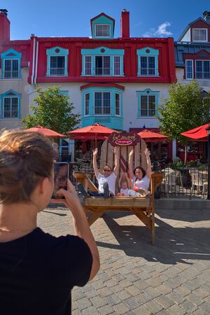 MONT-TREMBLANT, QUEBEC, CANADA, - SEPTEMBER 13, 2018: Mont-Tremblant ski resort, tourists at the main entrance, European view is a year-round ski resortのeditorial素材