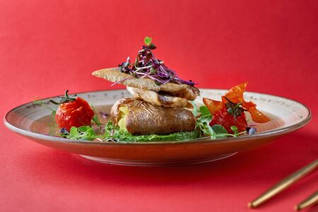 Roasted seabass fillet, served with spinach puree, peas with white onions and baked potatoes. Red...