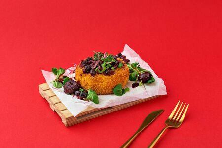 Delicious deep-fried mozzarella cheese in breadcrumbs served with prunes sauce.