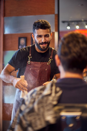 Shaving process of beards in Barbershop. Master makes the client shave his beard with vintage straight razor. Work in the Barber shop, The process of the hairdresser.の写真素材