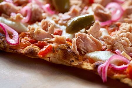 Delicious traditional Tarte Flambee from the Alsatian region of France with a thin crust of dough,...